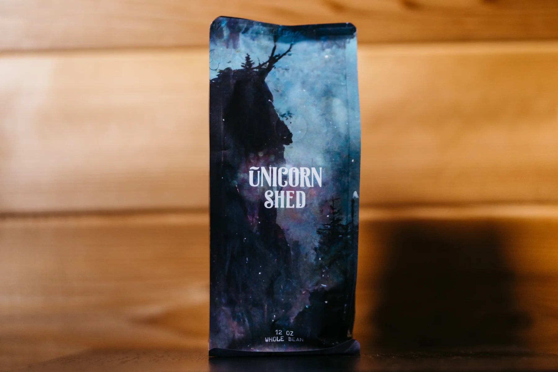 Unicorn Shed coffee on a wooden bench